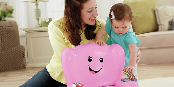 A lady helping a baby play with an educational toy.